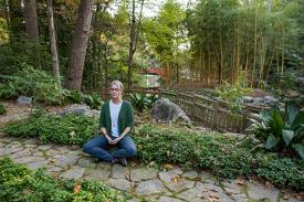 Betsy Dessauer meditates in the arboretum
